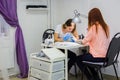 Manicurist treating client at beauty salon - painting on the nail Royalty Free Stock Photo