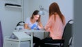 Manicurist treating client at beauty salon - painting on the nail Royalty Free Stock Photo