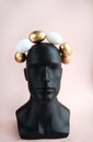 Maniken& x27;s head is decorated with decorative eggs,an Easter wreath . Creative Easter.