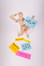 Manikin jointed doll holding a Help picket sign sticky notes SEO ranking keywords website