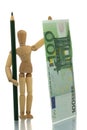 Manikin with pencil and money Royalty Free Stock Photo