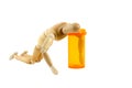 Manikin reaching in pill bottle Royalty Free Stock Photo