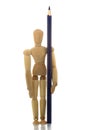 Manikin standing with pencil Royalty Free Stock Photo