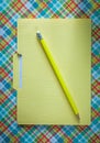 Manila file folder pencil on checked background Royalty Free Stock Photo