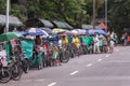Many philippine tricycles with drivers in road street