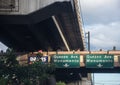 Pedestrian overpass obstructed by a train overpass, requiring pedestrians to duck.