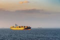 Newark container ship sails under sunset light to South Harbor, Manila, Philippines