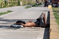 Manila, Philippines - May, 18, 2019: A poor man lying on the streets of Manila, sleeping