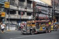 Jeepney taxi drives down the road in downtown Manila