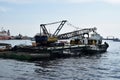 construction bulldozer crane truck working, loaded on floating steel platform