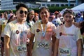 Smeared with colored dyes, Young people pose for picture during the street Fun Run festivity.