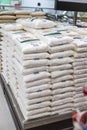 Manila, Philippines - A pile of 2 kilo white sugar bags on display at a supermarket