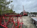 Manitowoc Red Crane Construction scene cloudy rainy day back lot view