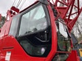 Manitowoc Red Crane Construction scene cloudy rainy day cab side view