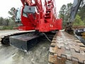 Manitowoc Red Crane Construction scene cloudy rainy day corner view