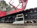 Manitowoc Red Crane Construction scene cloudy rainy day step ladder