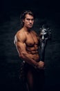 Manly athlete with sword and helmet in his hands