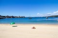 Sunbathing on the beach at Manly Cove, Sydney, Australia