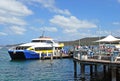 Manly Fast Ferry boat at Manly wharf ready to pick up passengers and depart to Sydney Cirqular Quay in the summer noon Royalty Free Stock Photo