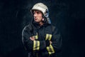 Manly firefighter in helmet looks sideways