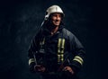 Manly firefighter in helmet looks sideways