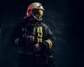 Manly firefighter in helmet looks sideways