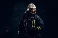 Manly firefighter in helmet looks sideways