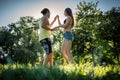 Mann turning woman dancing in the grass in summer park Royalty Free Stock Photo