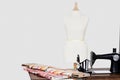 Mannequin with tailor sewing machine and fabric Royalty Free Stock Photo