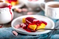 Manne cake with raspberry jam on a white plate. Tea party. Royalty Free Stock Photo