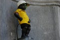 Manneken Pis dressed as a cyclist in yellow costume in Brussels, Belgium