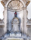 Manneken Pis, rocker look dress, a landmark 55.5 cm, 21.9 in bronze fountain sculpture in central Brussels, Belgium, depicting a