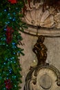 Manneken Pis (Little Man Pee), a bronze sculpture landmark near Grand Place, Brussels, Belgium,Christmas Royalty Free Stock Photo