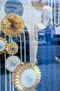 A mannequin in a blue dress in a New Year\'s showcase with gold large circles