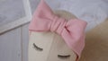 A mannequin with bow headband made out of knit fabric