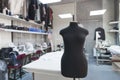 Mannequin without clothes standing on background sewing workshop. Design studio with fashionable clothes