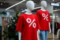 Mannequin in a clothing store in a red t-shirt with a percent sign Royalty Free Stock Photo