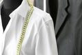 Mannequin with custom tailored shirt and measuring tape in atelier, closeup