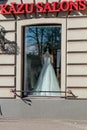 Wedding salon shop window with a mannequin doll in a bride`s dress.