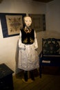 Mannequin dressed in an original historic Kashubian outfit inside a cottage in Poland