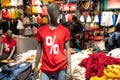 Mannequin dressed in red t-shirt with percentage sign and blue jeans in the shopping mall. Sale, discount, black friday