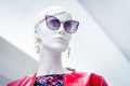 Mannequin face. Bright portrait of female beautiful dummy in purple sunglasses with earrings on isolated white background Royalty Free Stock Photo