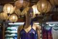 mannequin in halter neck summer dress, decorative lanterns above