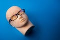 Mannequin head with black eyeglasses on background Royalty Free Stock Photo