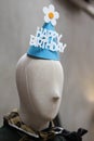 A paper hat with happy birthday banner