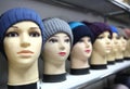 Mannequin heads in knitted hats and scarves. Mannequins female heads in hats and scarfs close up. Woolen knitted caps Royalty Free Stock Photo