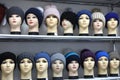 Mannequin heads in knitted hats and scarves. Mannequins female heads in hats and scarfs close up. Woolen knitted caps Royalty Free Stock Photo