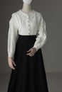 A mannequin with human hands dressed as a Victorian woman wearing a linen garibaldi blouse and black skirt Royalty Free Stock Photo