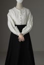 A mannequin with human hands dressed as a Victorian woman wearing a linen garibaldi blouse and black skirt Royalty Free Stock Photo