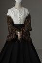 A mannequin with human hands dressed as a Victorian woman wearing a linen garibaldi blouse and black skirt Royalty Free Stock Photo